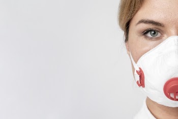 Portrait of adult woman wearing surgical mask Free Photo