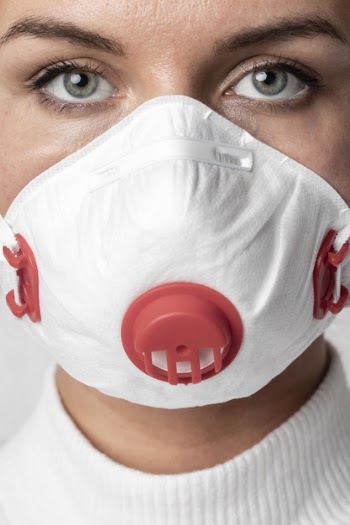 Portrait of adult woman wearing surgical mask Free Photo