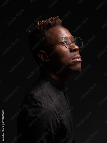 Portrait of an African man on a dark background. Studio shooting.
