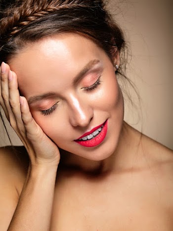 Portrait of beautiful woman model with fresh daily makeup and red lips touching her head Free Photo