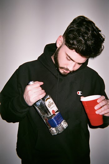 Portrait of Man in Hoodie  Holding Jose Cuervo Bottle and Solo cup 