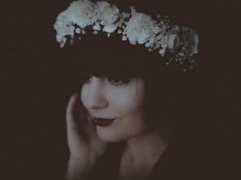 Portrait of Smiling Woman in White Floral Headband Posing