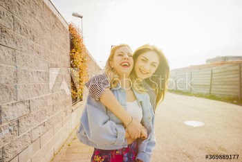 Portrait of smiling women standing on street