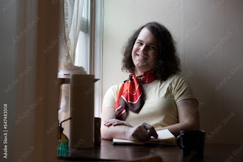 portrait of transgender woman sitting by window