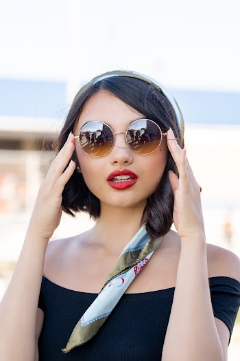 Portrait of Woman Holding Her Sunglasses