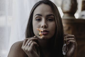 Portrait of Woman Holding Orange Flower