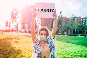 Portrait of woman holding placard claiming gender equality