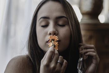 Portrait of Woman Kissing Orange Flowers