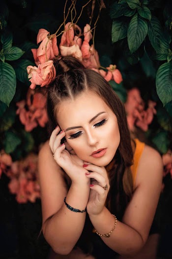 Portrait of Woman Surrounding of Orange Flowers