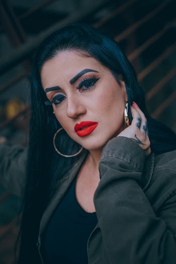 Portrait of Woman Wearing Gold-colored Loop Earrings