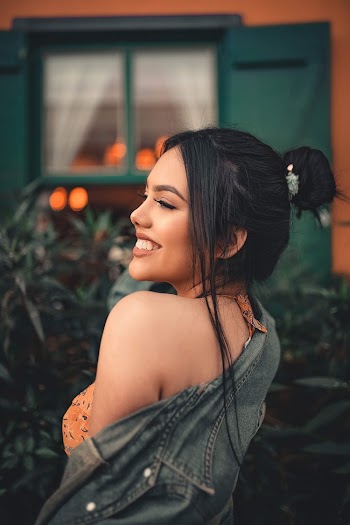 Portrait of Woman Wearing Orange Spaghetti Strap Blouse and Blue Denim Jacket