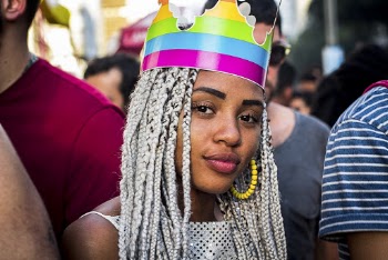 Portrait of Woman With White Braided Hair  and a Multicolored Paper Crown on Her Head