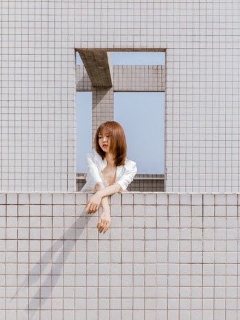 Portrait of Young Woman in Window · Free Stock Photo