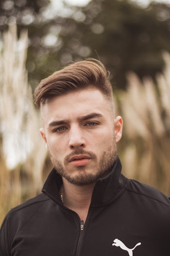 Portrait Photo of a Man in Black Puma Collared Top