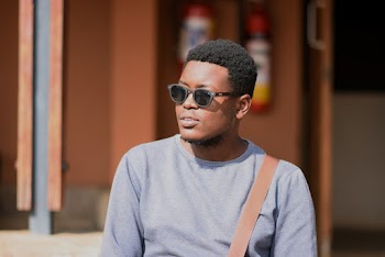 Portrait Photo of a Man Wearing Gray Crew-neck Shirt 