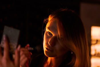 Portrait photo of a woman holding a makeup brush