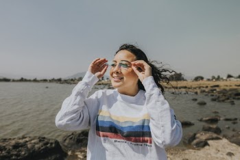 Portrait photo of a woman standing near body of water