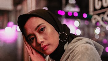 Portrait photo of a woman wearing black hijab
