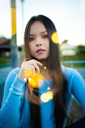 Portrait photo of a woman  wearing blue sweatshirt