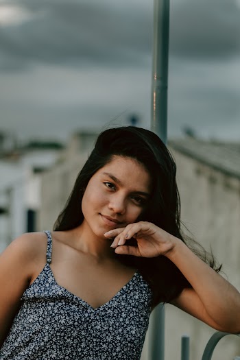 Portrait Photo of a Woman Wearing Floral Spaghetti Strap Top