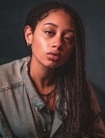 Portrait photo of a woman wearing grey denim top
