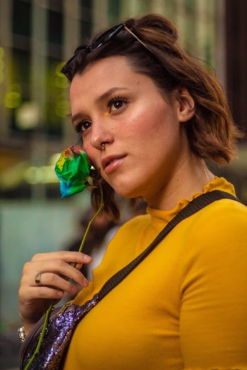 Portrait photo of a woman wearing yellow top