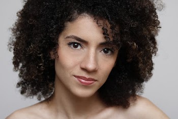 Portrait Photo of Curly-Haired Woman