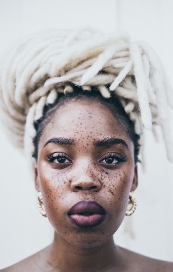 Portrait Photo of Freckled Woman With White Braids Posing