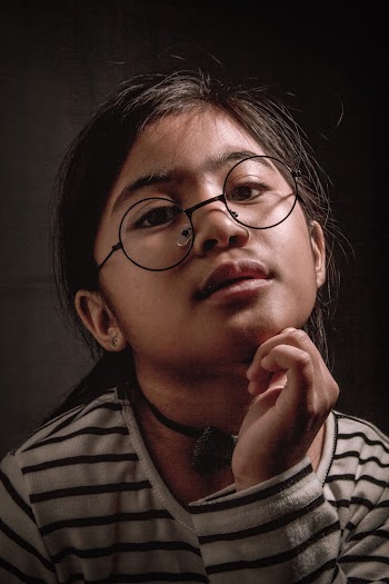 Portrait Photo of Girl in Black and White Striped Sweater With Black Framed Eyeglasses