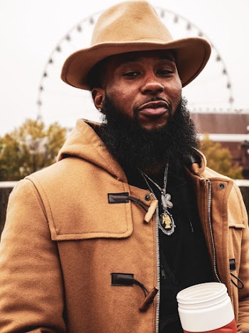 Portrait Photo of Man in Brown Outerwear and Hat Holding Plastic Tumbler