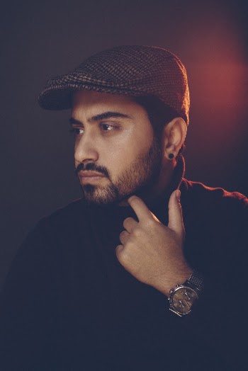 Portrait Photo of Man in Pull Neck Sweater and Flat Hat Posing