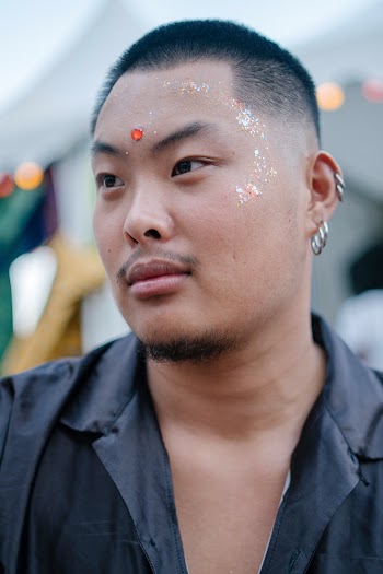 Portrait Photo of Man Wearing Silver-colored Earrings