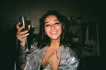 Portrait Photo of Smiling Woman Raising Up Champagne Glass With Beverage