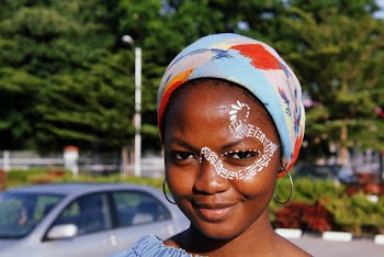 Portrait Photo of Smiling Woman With Face Paint