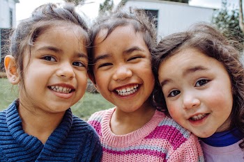 Portrait Photo of Three Smiling Girls