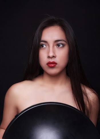 Portrait Photo of Topless Woman Posing In Front of Black Background