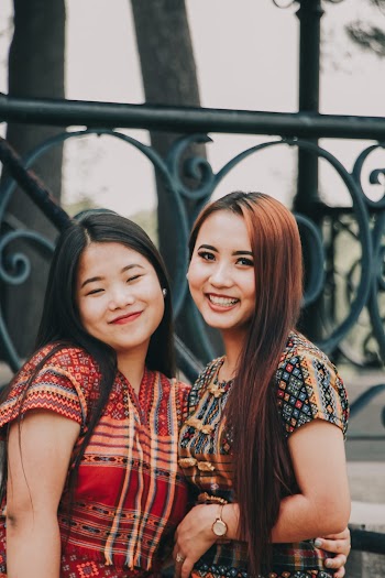 Portrait Photo of Two Smiling Women Posing