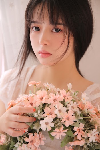 Portrait Photo of Woman Holding Flowers