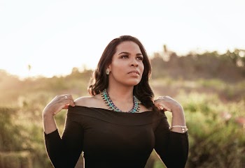 Portrait Photo of Woman in Black Off-shoulder Top Posing While Looking Away
