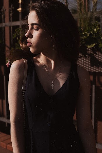 Portrait Photo of Woman in Black Outfit With Her Eyes Closed
