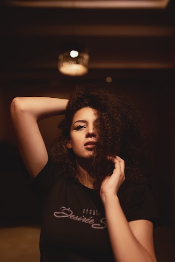 Portrait Photo of Woman in Black T-shirt Posing