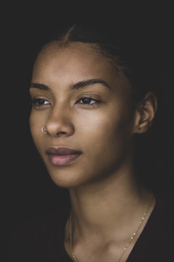 Portrait Photo of Woman in Black Top Wearing Necklace