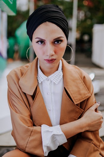 Portrait Photo of Woman in Black Turban and Brown Leather Jacket