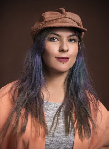 Portrait Photo of Woman in Brown Cap and Peach Cardigan Posing