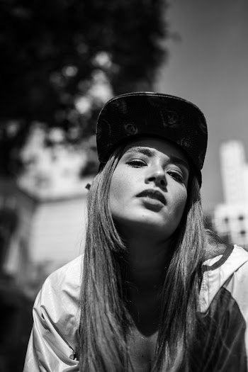 Portrait Photo of Woman in Flat-brimmed Cap