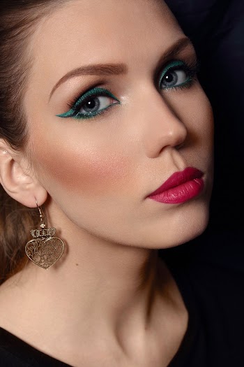 Portrait Photo of Woman in Make-up Wearing Gold-colored Chandelier Earring
