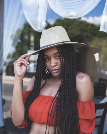 Portrait Photo of Woman in Red Crop Top and White Hat Posing