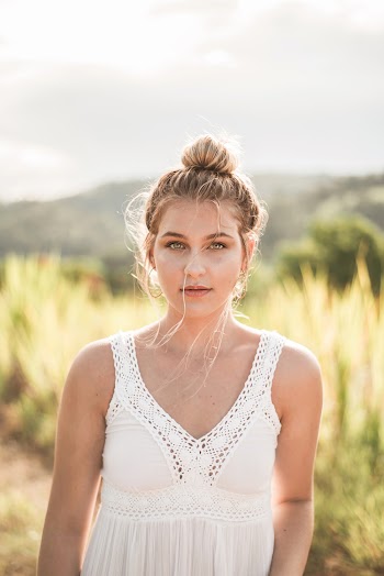 Portrait Photo of Woman in White Sleeveless Top