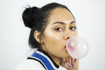 Portrait Photo of Woman Making Bubble Using Chewing Gum