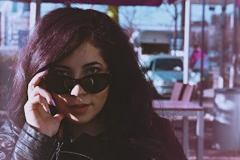 Portrait Photo of Woman Posing in Black Sunglasses
